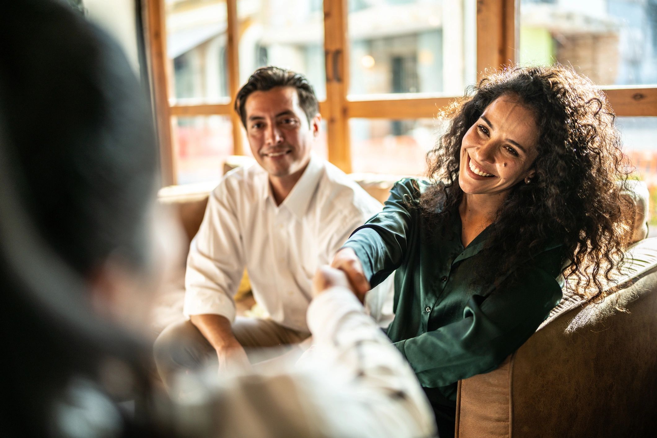 Two people shaking hands representing trusted service