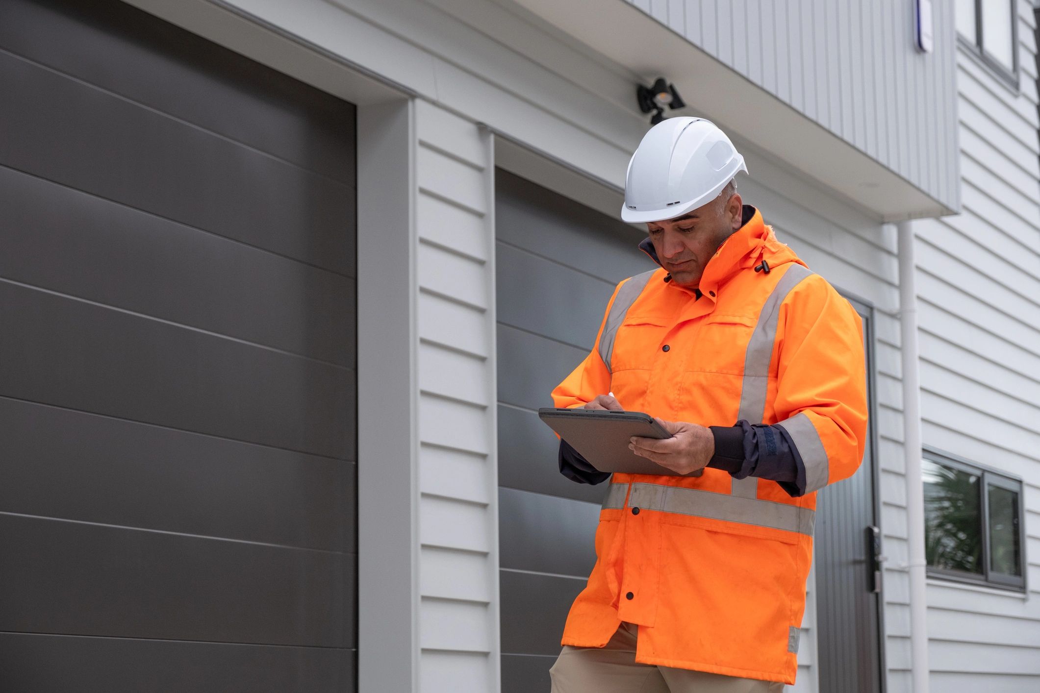 Construction manager checking documents on a tablet