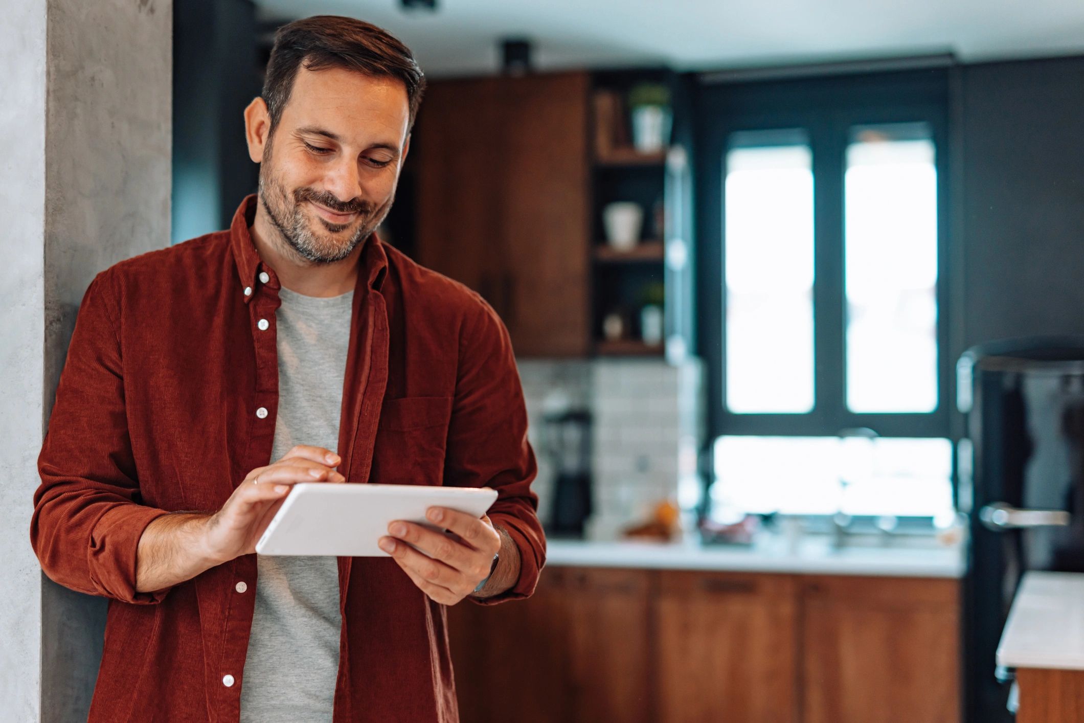 Homeowner using a tablet to review a home maintenance plan
