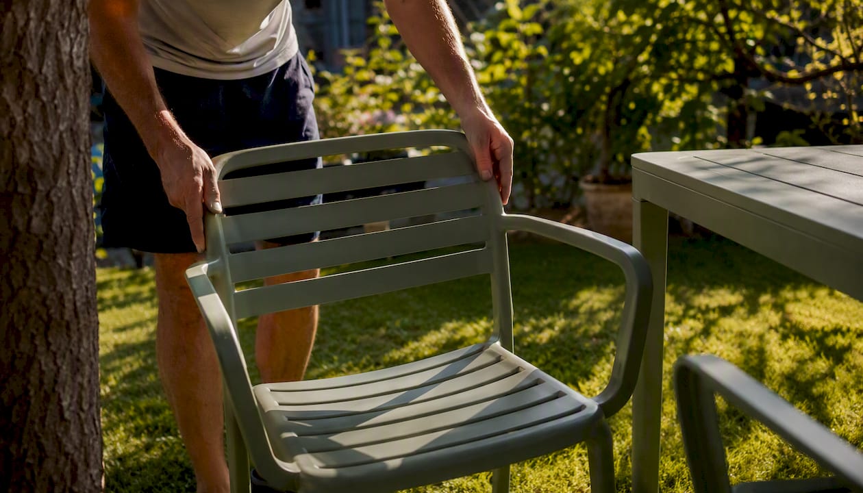 Moving plastic furniture into sunny spot on patio